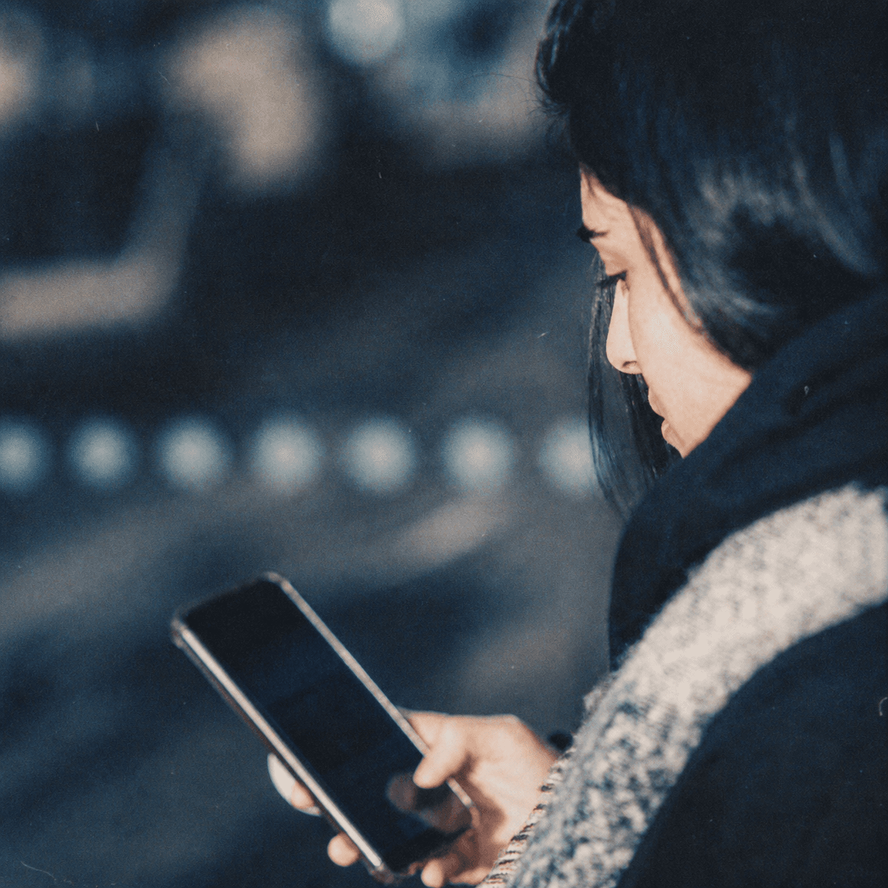 Person using a phone on a street