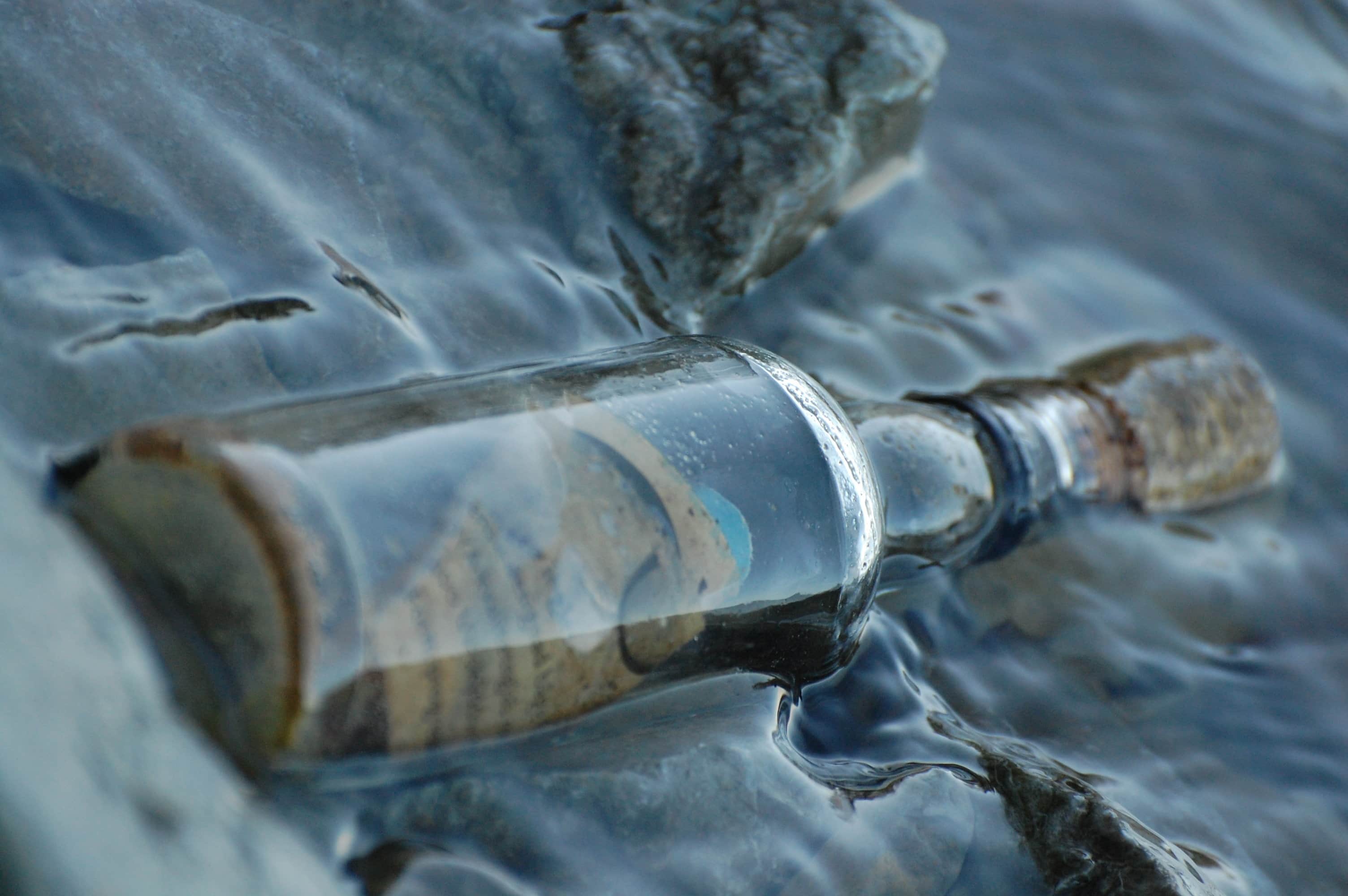 A message inside a glass bottle floating in water